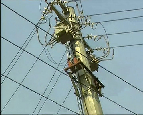 Video still showing a post with electric wires.