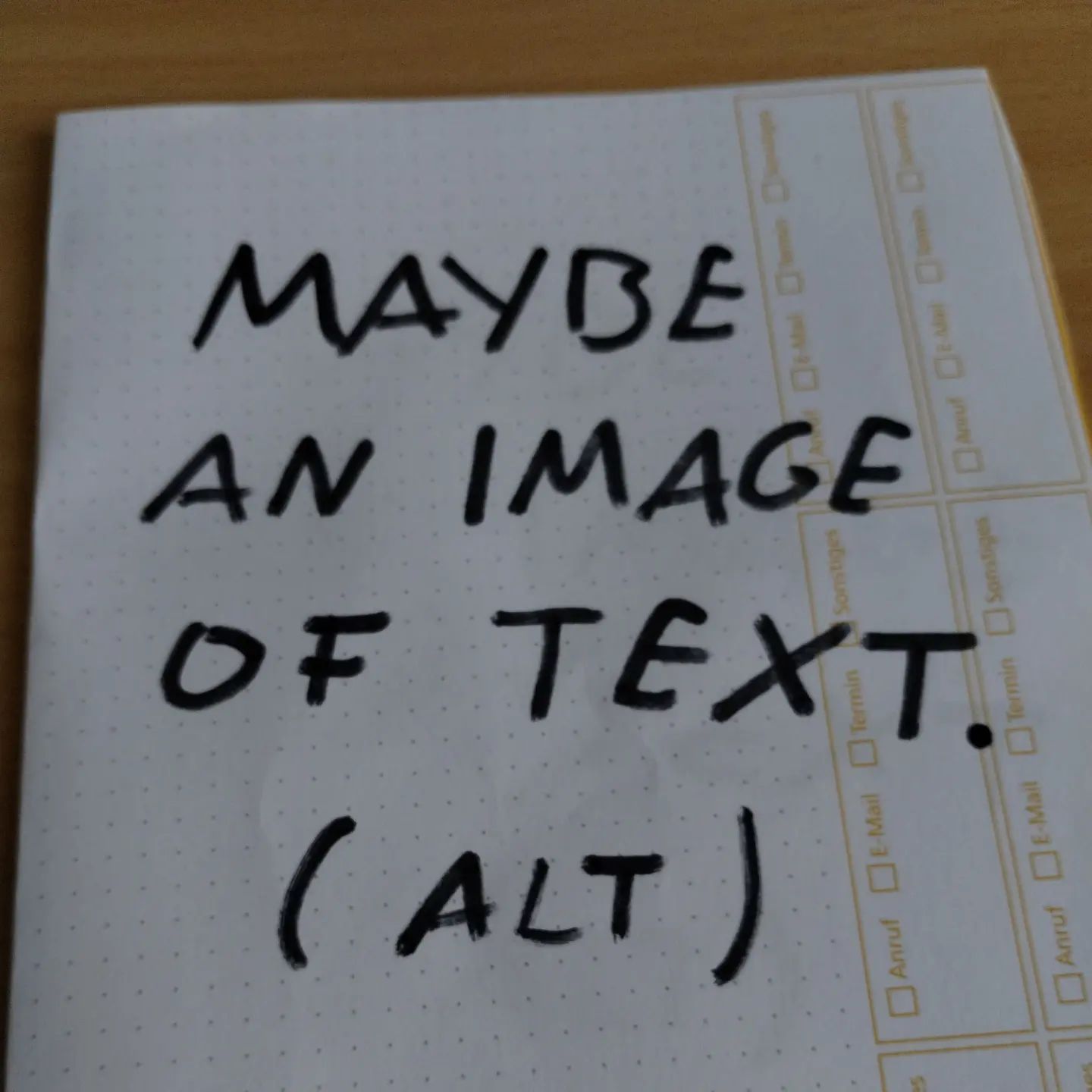 Photo of handwritten text on paper:	Maybe an image of text.	(ALT)