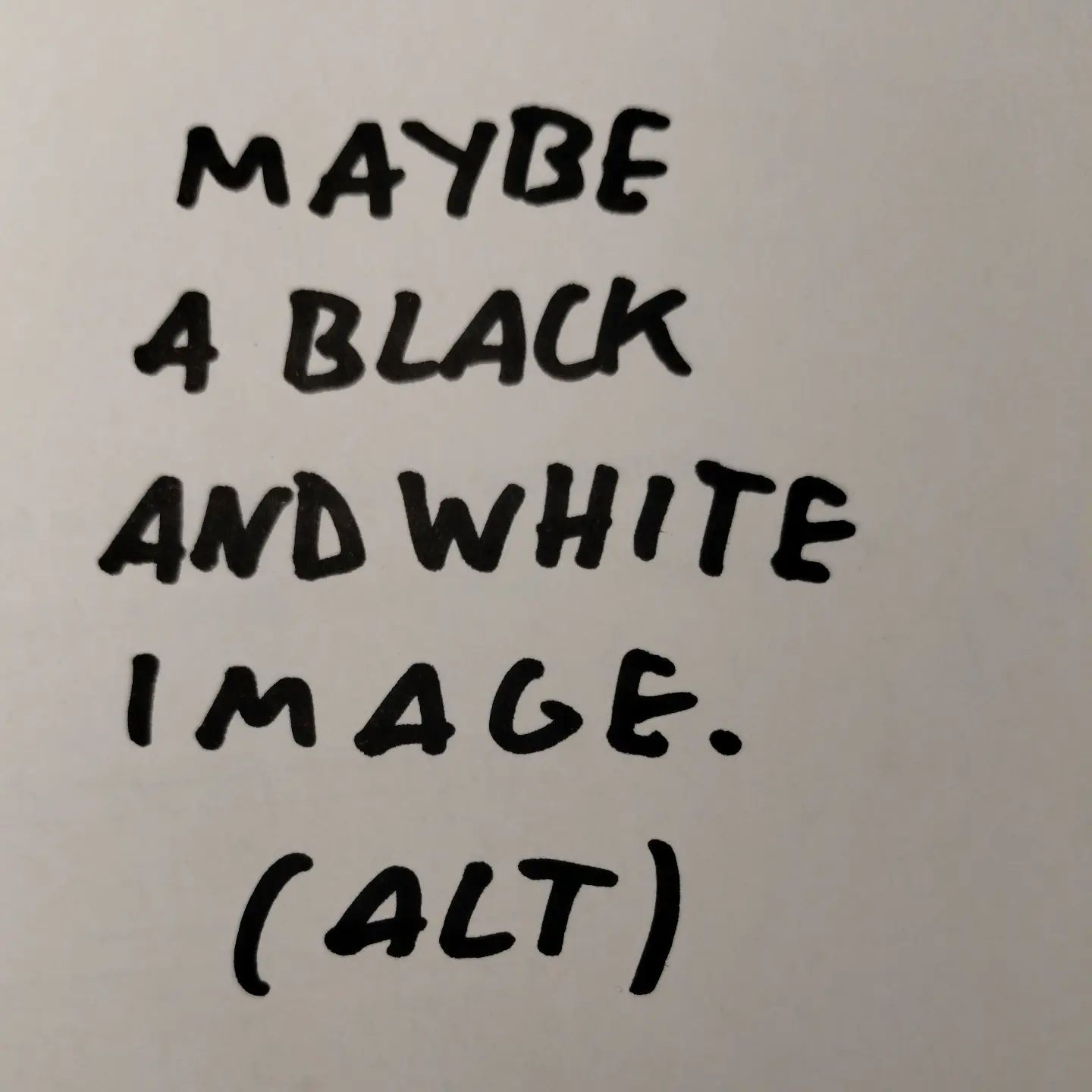 Photo of handwritten text on paper: Maybe a black and white image.	(ALT)